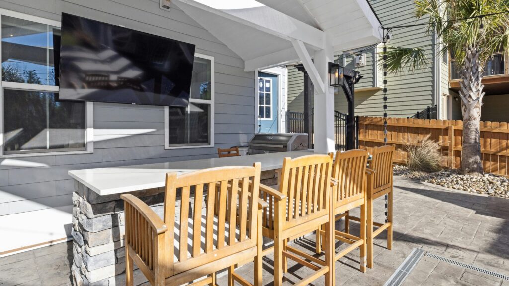Covered outdoor living space ideas featuring a cozy patio with fireplace and outdoor chandelier