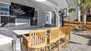 Covered outdoor living space ideas featuring a cozy patio with fireplace and outdoor chandelier